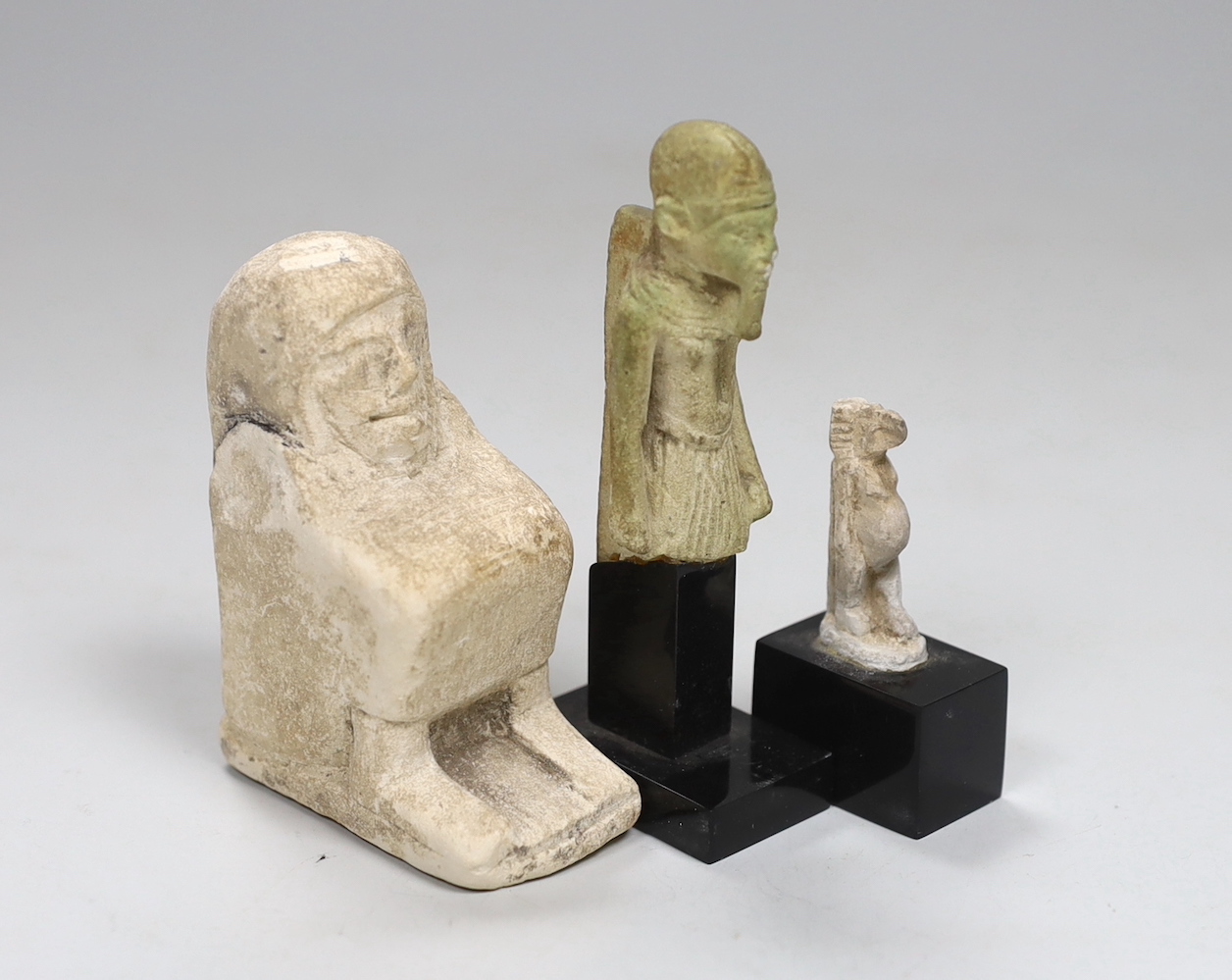 Three Ancient Egyptian pottery statuettes, largest 5cm wide, 7.5cm high